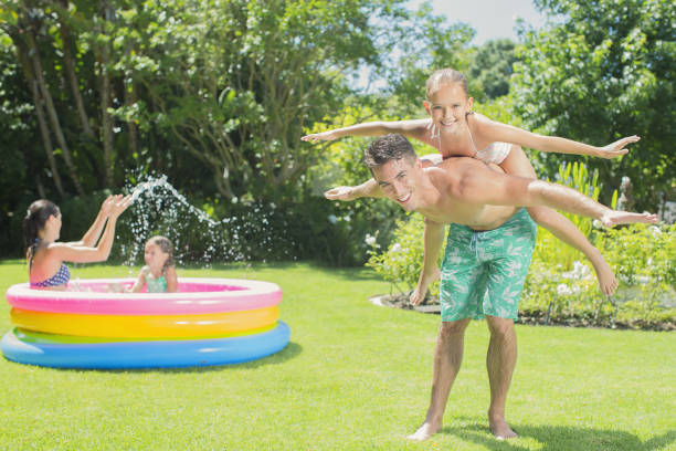 istock Father and daughter playing in backyard 457981965