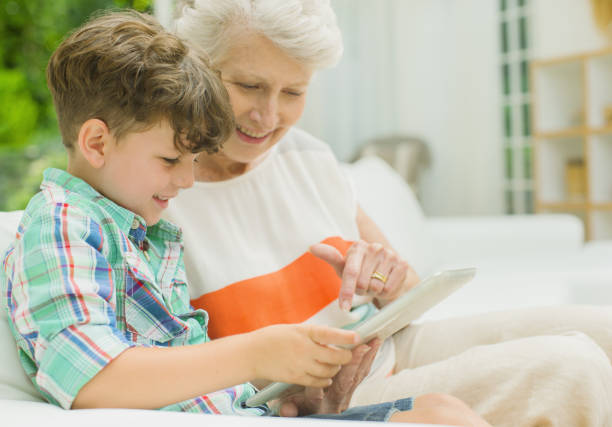 istock Older woman and grandson using digital tablet 457981977