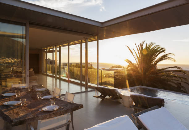 istock Patio overlooking swimming pool and ocean at sunset 457982217