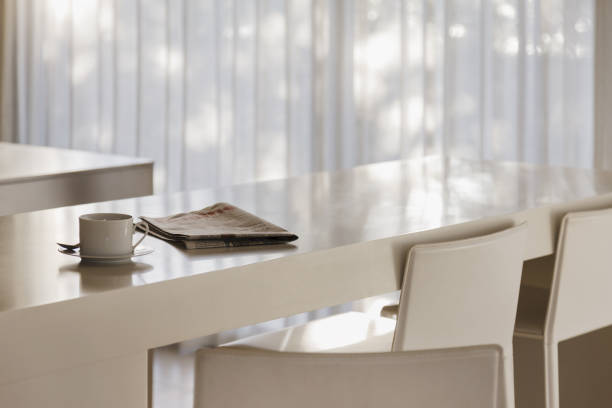 istock Coffee and newspaper on breakfast bar in modern kitchen 457982281