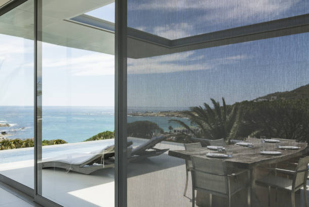 istock View of ocean beyond patio and swimming pool 457982329