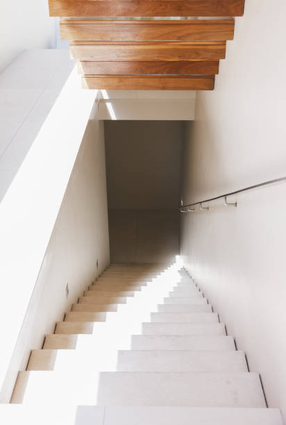 istock Light shining down staircase in modern house 457982523
