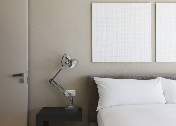istock Lamp and wall art in modern bedroom 457982535