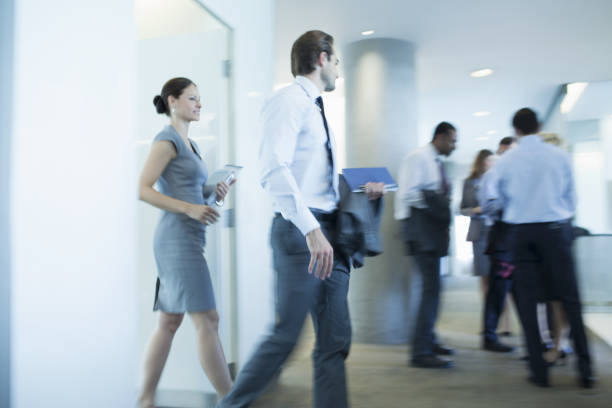 Business people walking in office  caucasian appearance stock pictures, royalty-free photos & images