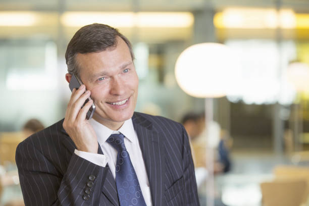 istock Businessman talking on cell phone in office 457983219