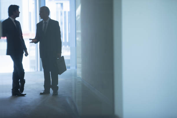 istock Businessmen talking in office corridor 457983551