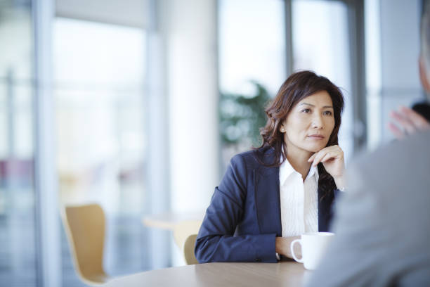 Business people talking in meeting  hand on chin stock pictures, royalty-free photos & images