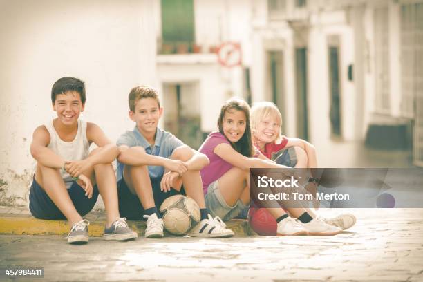 Children With Soccer Balls Sitting On City Street Stock Photo - Download Image Now - Teenage Boys, Street, Teenager
