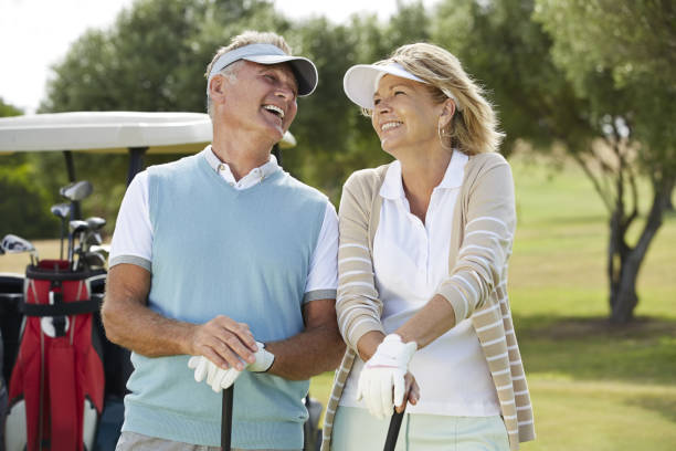 istock Senior couple laughing on golf course 457984557