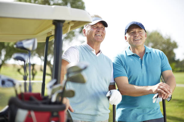 istock Senior man standing next to golf cart 457984589