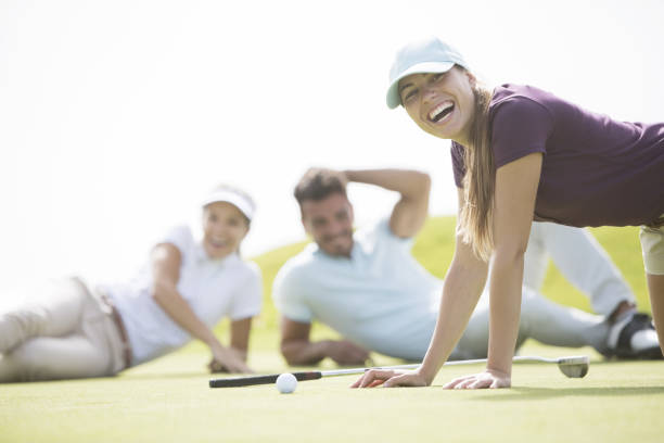 istock Friends laying and laughing on golf course 457984677