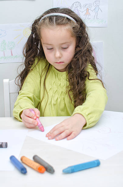 istock Little girl drawing with crayons 458005299