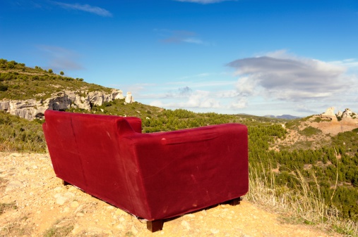 Red couch outdoors. Location: Cote d'Azur, France
