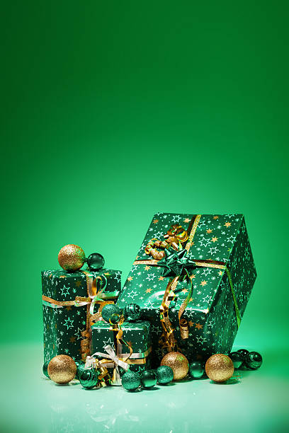 istock Gift boxes and christmas balls,Isolated on green background 458012989