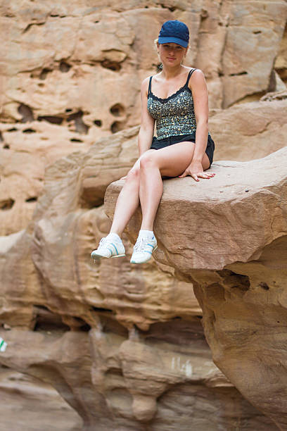 istock Girl sitting on a rock. 458049791