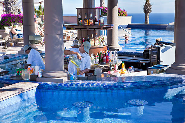 Bartenders Working a Pool Bar in Mexico stock photo