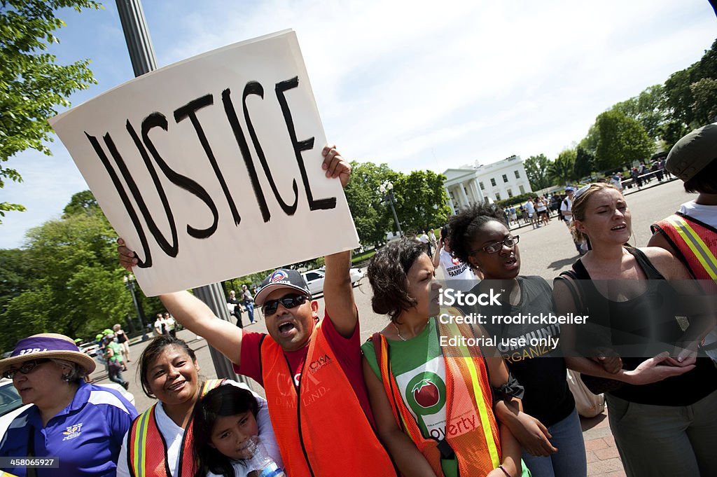 Protest at White House "WASHINGTON, DC, USA - May, 1 2010: An immigration reform activist holds a sign reading &quot;Justice&quot; during a protest at the White House." Protest Stock Photo