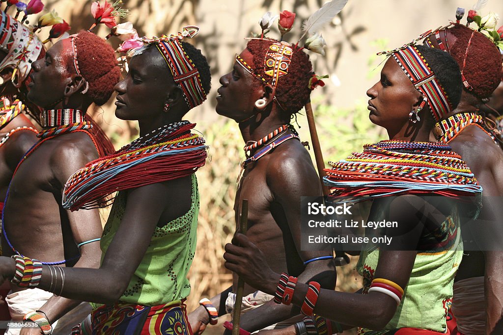 Young Samburu tribal dancers at a tourist lodge, Kenya "Samburuland, Isiolo district, Kneya - 27 July 2006:Samburu tribal morani (warriors, young men) often come down with teen girls to the safari lodges to earn some money by explaining their tribal traditions and performing traditional dances to tourists. In this photo, they are wearing traditional clothes and beadwork and some of the morani are decorated with ochre clay." Adult Stock Photo