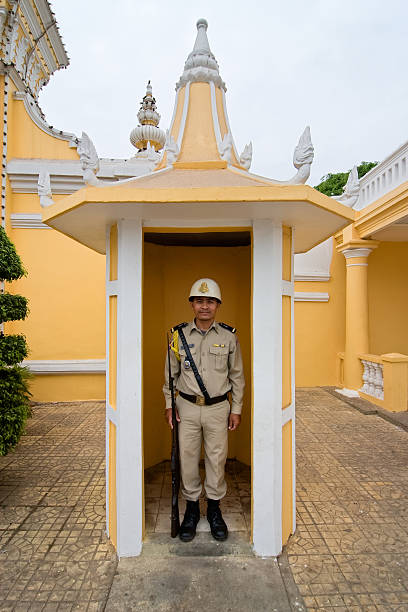 Guard at his post outside the palace in Phnom Penh. stock photo