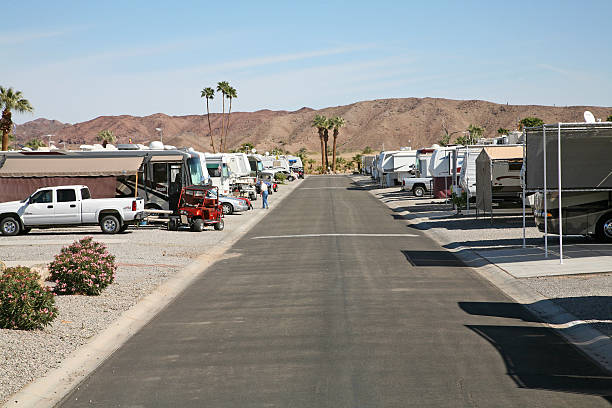 Motor Home Wintering In The Desert "Yuma, Arizona,United States - March 12, 2008 : Street of semi permanant RV\""S and Motor Homes located at Hidden Shores RV Park outside of Yuma on the Colorado River. Senior Man in mid frame." yuma photos stock pictures, royalty-free photos & images
