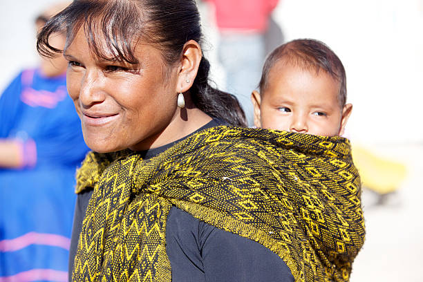 Samachique, Chihuahua, Mexico - March 25, 2010: Sierra Madre Tarahumara Native people - young mother with baby in carrier