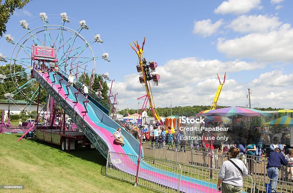 Slide and rides "Burton, Ohio - September 5, 2010: Riders have fun on the Super Slide and other rides at the 188th annual Great Geauga County Fair in Burton, Ohio." Agricultural Fair Stock Photo