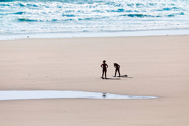 две женщины surfers - wales beach editorial people стоковые фото и изображения