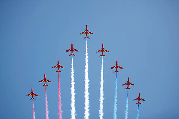 The Red Arrows "Cardiff, Wales - June 26, 2010: The famous RAF Red Arrows squadron flying in formation at an air show in Cardiff, Wales, June 26, 2010." british aerospace stock pictures, royalty-free photos & images