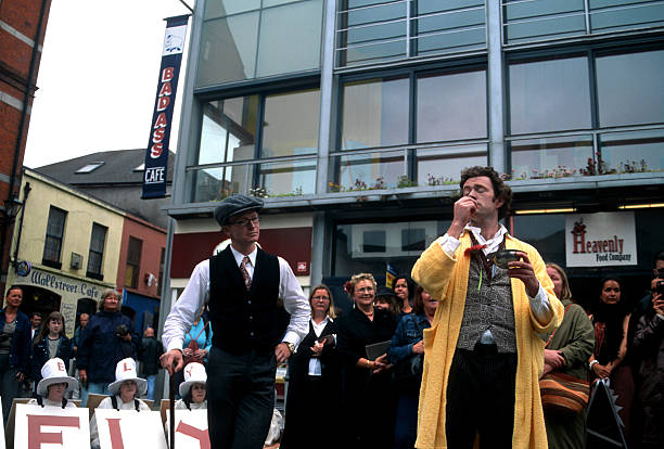 Dubliners celebrating the Bloomsday "Dublin, Ireland - June 16 2005: Streets performers celebrating the Bloomsday, local holiday in honor of the writer James Joyce, with the play Dubliners." bloomsday stock pictures, royalty-free photos & images