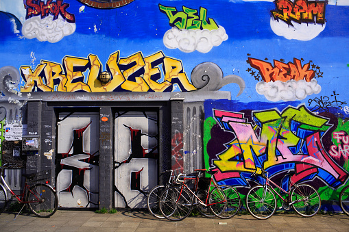 Berlin, Germany- April 22, 2011: Graffiti at Kreuzberg Berlin Germany. Bicycles leaned on wall painted with colorful graffitis in the district of Kreuzberg. This districtit is well known to be the home of the counterculture movement in the city.