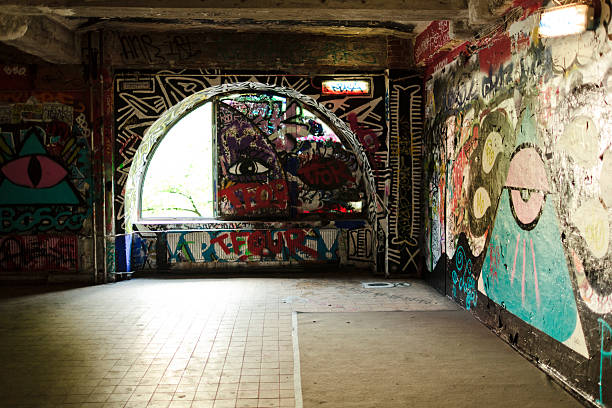 Abstract smiling face on wall with colorful graffiti and splashed paint.
