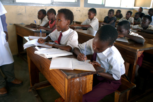 Side view female students listening to teacher in class