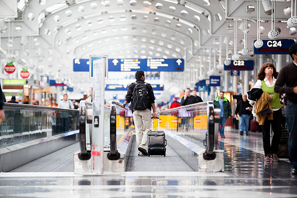 Passenger walking through Chicago O'Hare International Airport stock photo