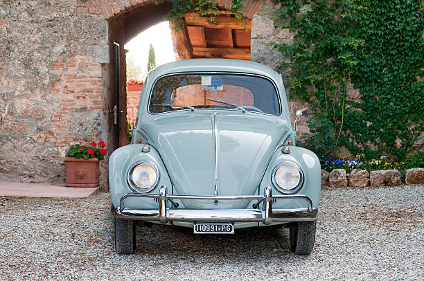 Volkswagen beetle car "Siena, Italy - June 25, 2011: Vintage antique Volkswagen Beetle car parked in a backyard in Tuscany." beetle stock pictures, royalty-free photos & images