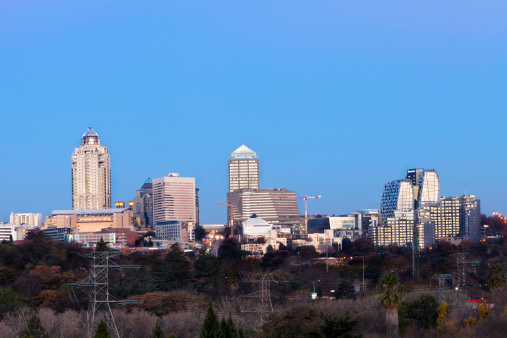 Johannesburg, South Africa - July, 28th 2012: Sandton city skyline at sunset, home to most of the major financial, consulting and banking firms in South Africa. Power cables seen below.