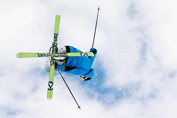 Freestyle skier "Crans Montana, Switzerland - April 18th, 2009: Freestyle skier in Funpark, jumping overhead, crossing skis" crans montana stock pictures, royalty-free photos & images