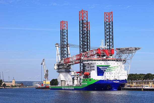 Ship for installing offshore wind turbines "Gdansk, Poland - July 31, 2012: Specialist ship ""Innovation"" with a heavy crane system for building and operating offshore wind farms. Can carry cargo weighing up to 1,500 tons." floating electric generator stock pictures, royalty-free photos & images