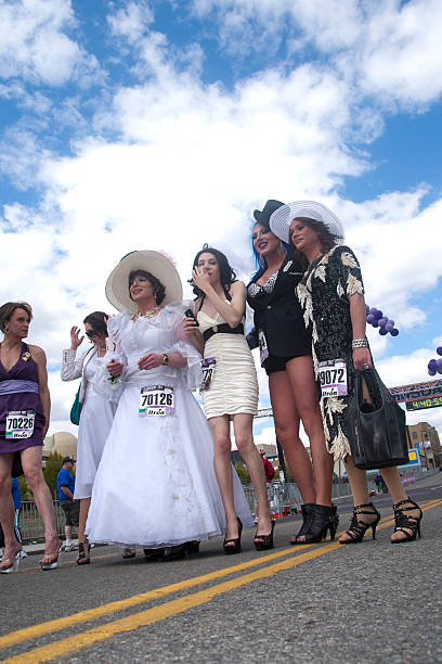 Drag queens on the road. "Spokane, Washington - May 6, 2012.  Local drag queens walk the entire 7 1/2 miles in high heels at the bloomsday race." bloomsday stock pictures, royalty-free photos & images