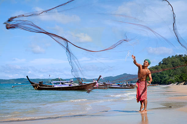 Fishermen in a Boat Catch Fish by Throwing Net in To the Backwaters  Editorial Stock Photo - Image of asia, resources: 59250128
