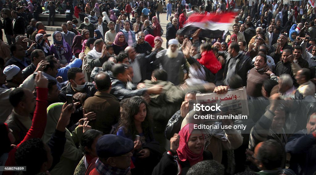 Men celebrating Mubarak’s step down in Tahrir sq. "Cairo, Egypt - February 12, 2011: Egyptians take to Tahrir Sq. - downtown Cairo, this time to celebrate the success of the Egyptian revolution.. Mubarak steps down as the president of Egypt on the 11\'th of October after more than 20 million Egyptians showed their rejection of Mubarak in the streets of Egypt and around his presidential palace. The uprising in Egypt started out from social networks on January 25\'th 2011, following a similar successful uprising in Tunis." Protest Stock Photo