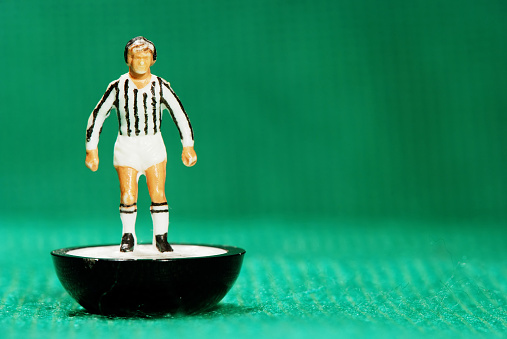 Pila, Italy - May 26, 2011: Vintage Subbuteo miniature toy of a soccer player of Juventus Football Club team from Turin, Italy. Subbuteo is a set of table top games simulating team sports such as soccer, cricket, rugby and hockey created by Peter Adolph.