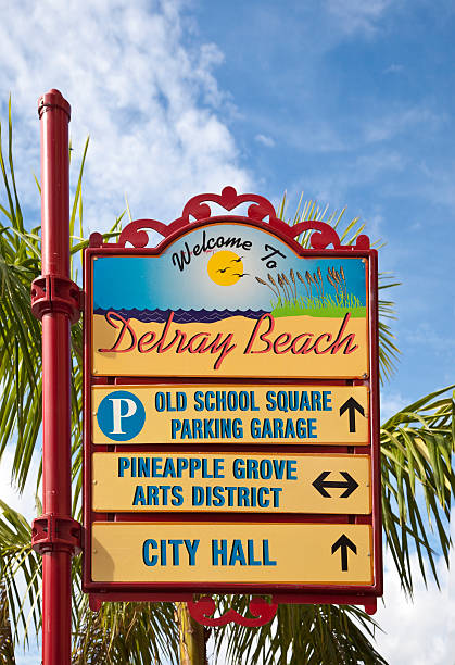 Welcome to Delray Beach "Delray Beach, Florida, USA - January 1, 2010: A colorful street sign with a background of palm trees welcomes visitors to Delray Beach Florida." delray beach fl stock pictures, royalty-free photos & images
