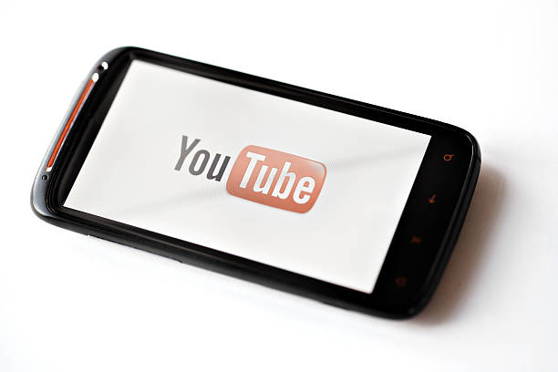 Youtube phone Bucharest, Romania - March 28, 2012: Youtube logo is displayed on a mobile phone screen. YouTube is a video-sharing website, on which users can upload, view and share videos. movie sound clips stock pictures, royalty-free photos & images