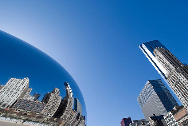 Chicago Reflections "Chicago, USA - March, 26th 2010: Chicago reflected in the Cloud Shape at the Millennium Park, a public park in the Loop area of Chicago. It was designed for the change of the millennium but was finished in 2004. The Cloud Shape is a design from Anish Kapoor. Constructed between 2004 and 2006, the sculpture is nicknamed The Bean." millennium park stock pictures, royalty-free photos & images