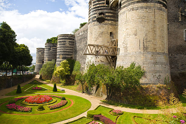 Angers Chateau, France "Angers, France - July 23, 2009: Panoramic of Angers Chateau and garden in a summer day. Some people are looking from the gateway" loire valley photos stock pictures, royalty-free photos & images