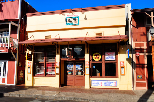 Lahaina, United States - July 14, 2012: Facade of the Lahaina Mai-Tai Lounge, an establishment in  the heart of Lahaina's tourist district just prior to opening for the morning tourist traffic.