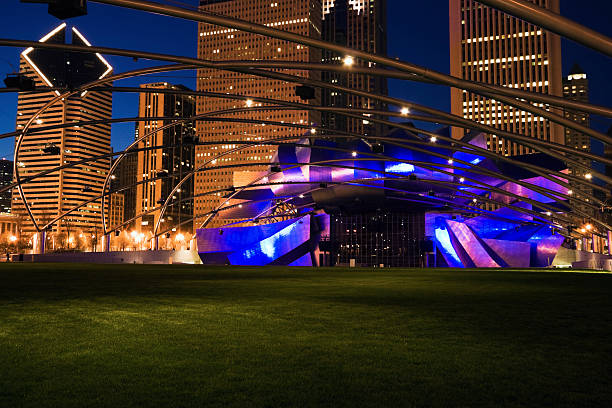 Jay Pritzker Pavilion "Chicago, Illinois, USA - April 21, 2007: Jay Pritzker Pavilion in Millenium Park and Randolph Avenue Buildings in Chicago. Seen during spring evening." millennium park chicago stock pictures, royalty-free photos & images