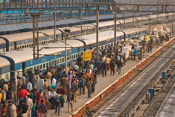 Indian Railways "New Delhi, India - February 5, 2009: Crowded platform and trains at New Delhi railway station in Delhi, India. The railway network in India is very extensive and is the most common way in which people travel long distances. New Delhi station is one of the main railway hubs in the country." india train stock pictures, royalty-free photos & images