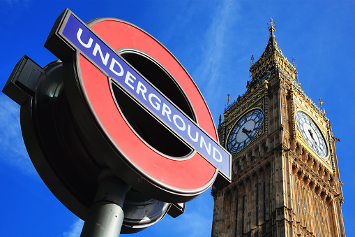 London, UK - Apr 9, 2011: London Underground sign at Westminster tube station with Big Ben in the background 