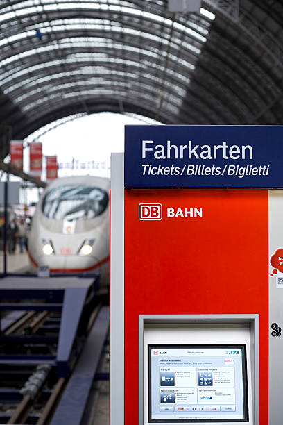 Ticket machine on the railroad station platform "Frankfurt, Germany - June 20, 2011: Modern ticket machine with touch screen technology on the railroad station platform at main station Frankfurt, Germany. In the background a waiting ICE high speed train." deutsche bahn stock pictures, royalty-free photos & images